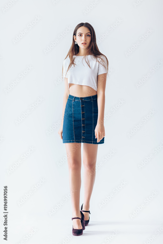Full length portrait of walking beautiful girl in studio on white background Full length portrait of walking beautiful girl in studio on white background