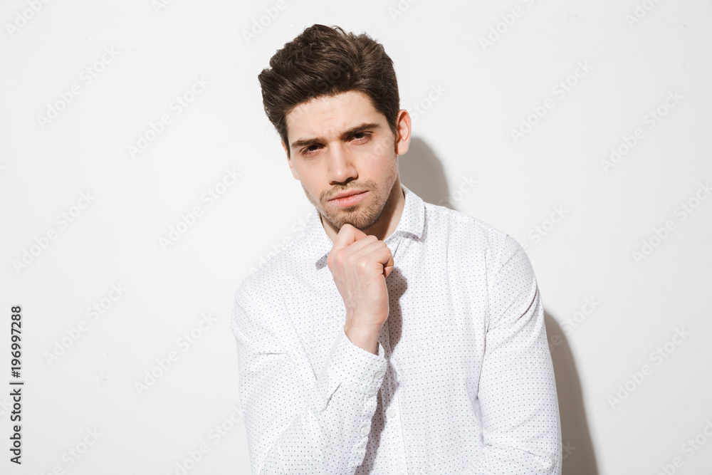 Portrait of a pensive charming man dressed in shirt Portrait of a pensive charming man dressed in shirt