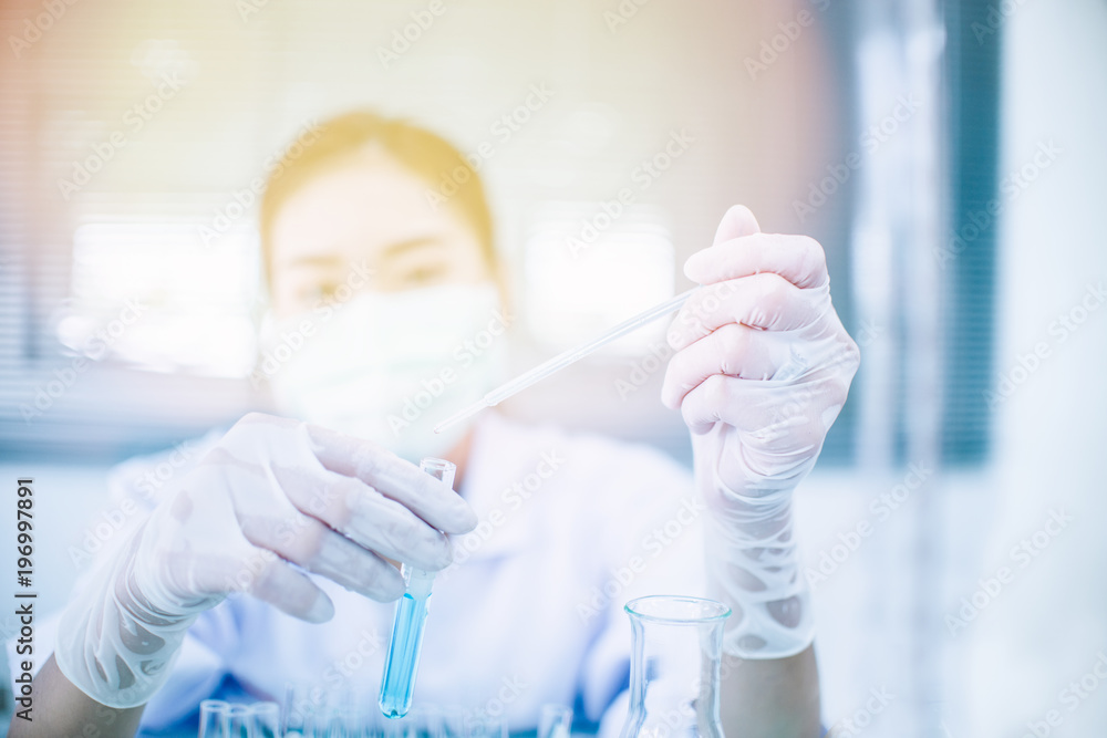 Asian women scientist with test tube making research in clinical laboratory.Science, chemistry, technology, biology and people concept Asian women scientist with test tube making research in clinical laboratory.Science, chemistry, technology, biology and people concept