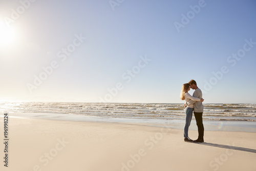 Romantic Couple Embracing On Winter Beach