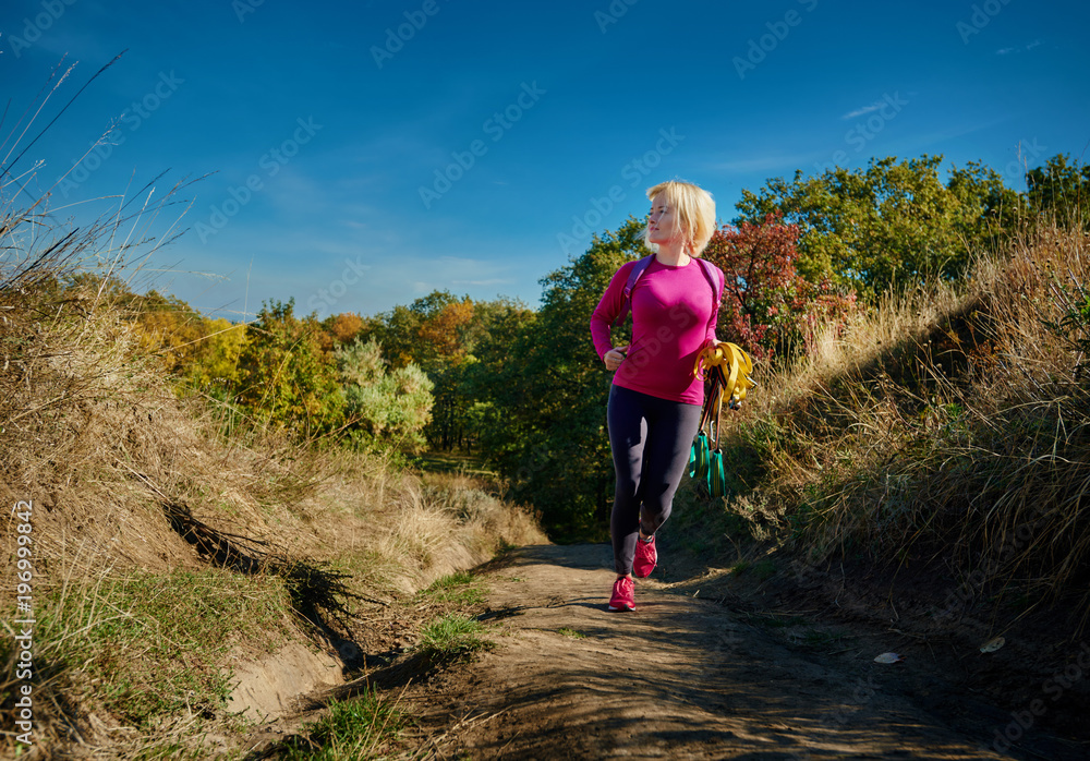 Fototapeta premium Fitness woman with resistance rope training on fresh air