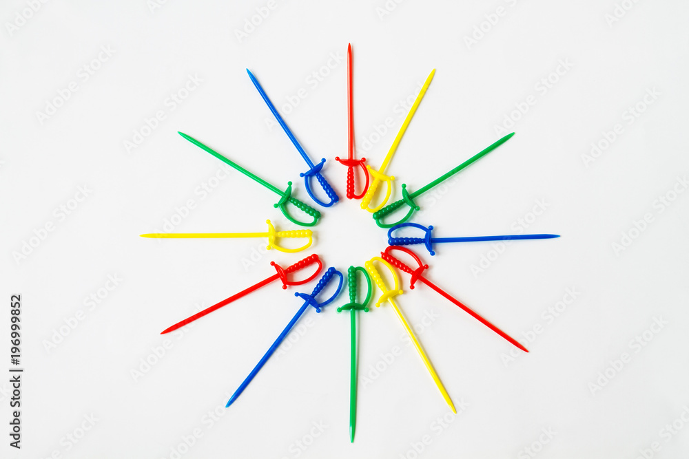 Colorful plastic skewers on a white background