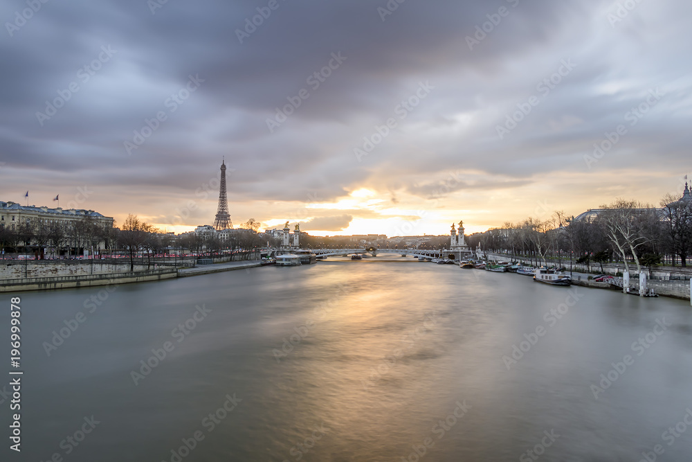 Long exposure of amazing sunset in Paris, with Seine river, Pont Alexandre III and Eiffel tower