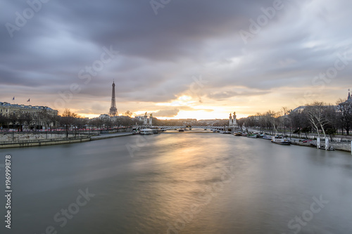 Long exposure of amazing sunset in Paris, with Seine river, Pont Alexandre III and Eiffel tower