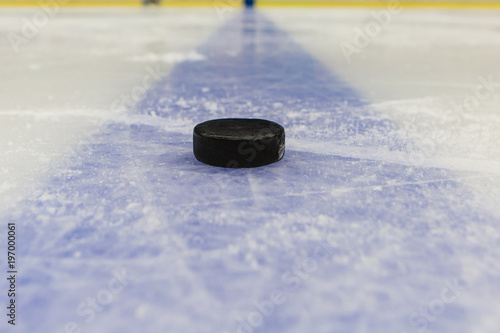 blue line with puck on ice hockey rink