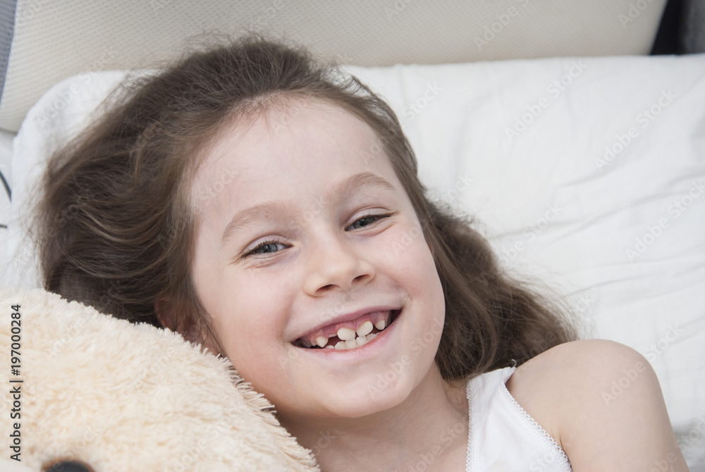 Cute Smiling Little Girl Woke up in White Bed. Morning in Wekeend. Flat Lay. Top view. Sleeping children. Cute Smiling Little Girl Woke up in White Bed. Morning in Wekeend. Flat Lay. Top view. Sleeping children.