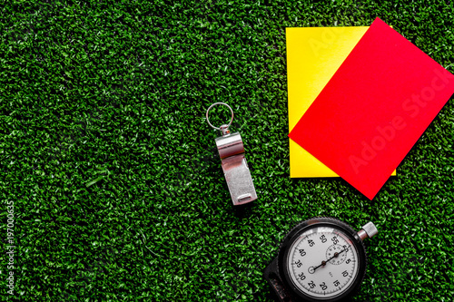 red and yellow cards on green background top view