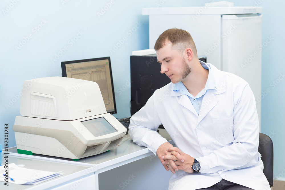 Research or genetics scientist using laptop in medical office or laboratory. Research or genetics scientist using laptop in medical office or laboratory.