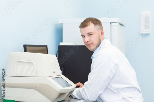 Research or genetics scientist using laptop in medical office or laboratory.