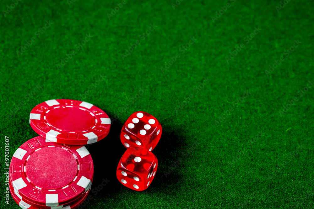 poker chips and dice on green background top view poker chips and dice on green background top view