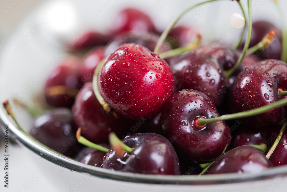 Cherries on wooden table with napkin and water drops macro background Cherries on wooden table with napkin and water drops macro background