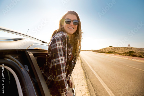 happy girl looking out the car window
