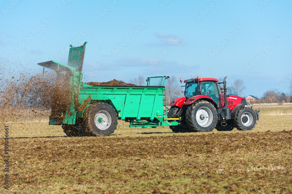 Tractor with manure spreader on the field - 1292 Tractor with manure spreader on the field - 1292
