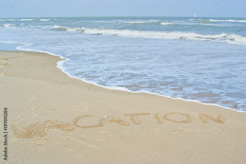 Beach with the word vacation written in the sand, summer holiday concept
