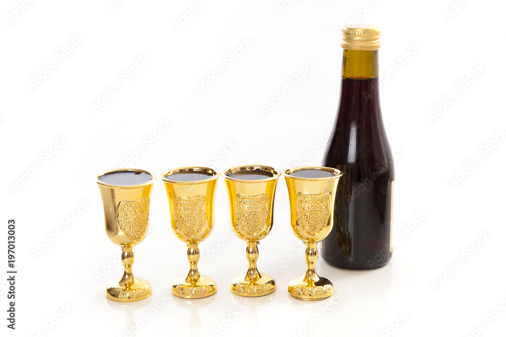 Fototapeta passover elements on studio shite background, matzoh, wine, goblets, walnuts