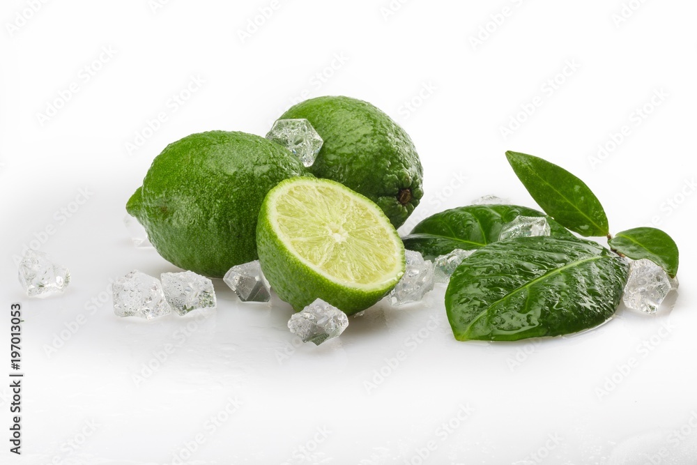 Fresh Limes with Leaves and Ice Cubes