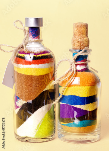 Glass bottles with colored sand. Sand art in a bottle photo