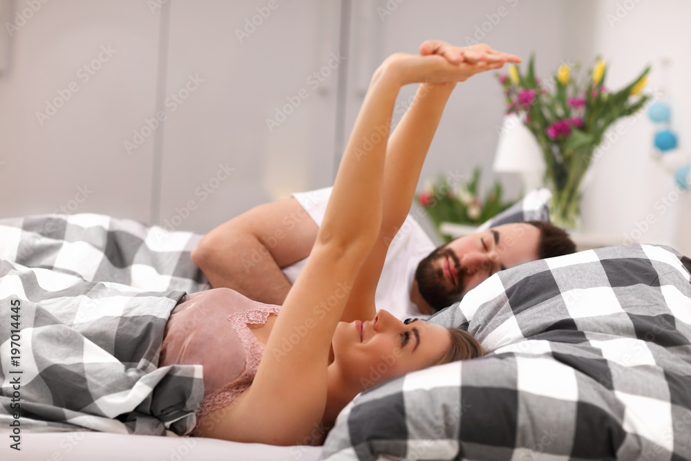 Adult attractive couple in bed