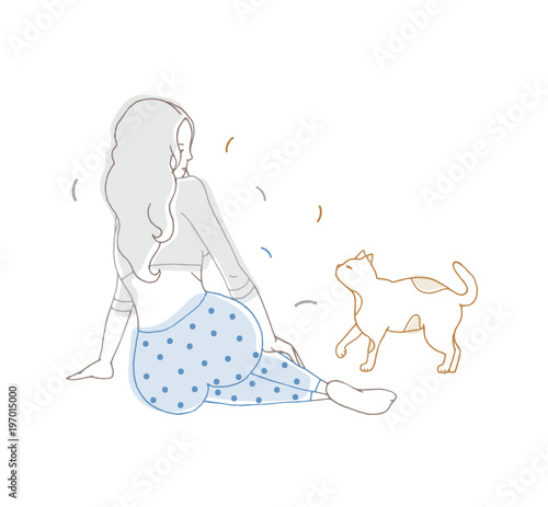 Girl with long loose hair dressed in dotted pajamas sitting on floor and look...