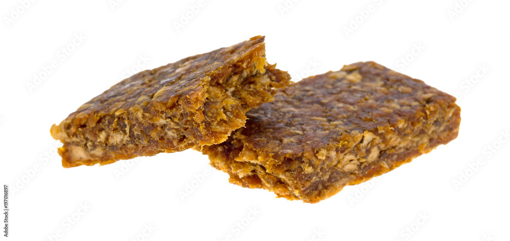 Side view of a broken in half apple energy bar isolated on a white background.