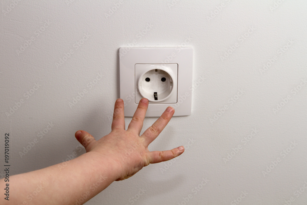electrical security for safety home of ac power outlet for babies, baby hands playing with electric plug electrical security for safety home of ac power outlet for babies, baby hands playing with electric plug