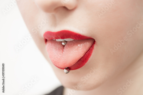 Wallpaper Mural woman's mouth with red lips opened and with a piercing in a tongue
