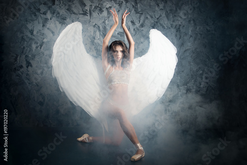 Ballet dncer woman in role of white angel. Artistic photo