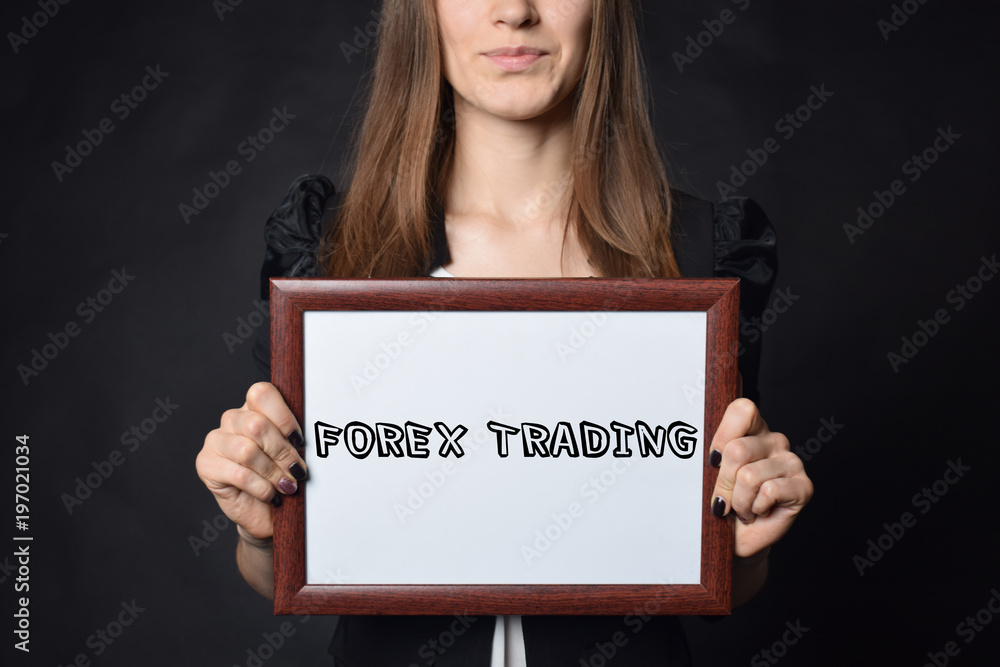 In the hands of a businessman a frame with the inscription:FOREX TRADING In the hands of a businessman a frame with the inscription:FOREX TRADING