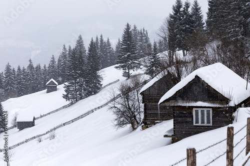 Old wooden houses in a mountain village in Romania © Sebastian Studio