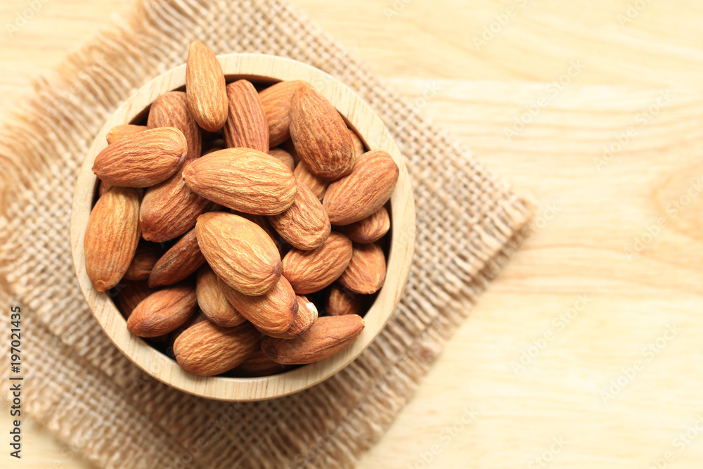 Almond in a bowl on wooden background with copy space Almond in a bowl on wooden background with copy space
