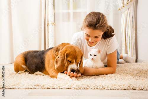 the girl is relaxing with her pets