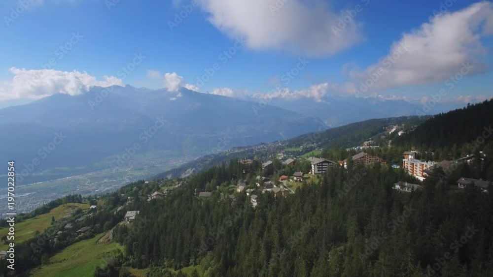 Swiss alps holiday resort - cinematic drone shot. Beautiful aerial panorama in the mountains Swiss alps holiday resort - cinematic drone shot. Beautiful aerial panorama in the mountains