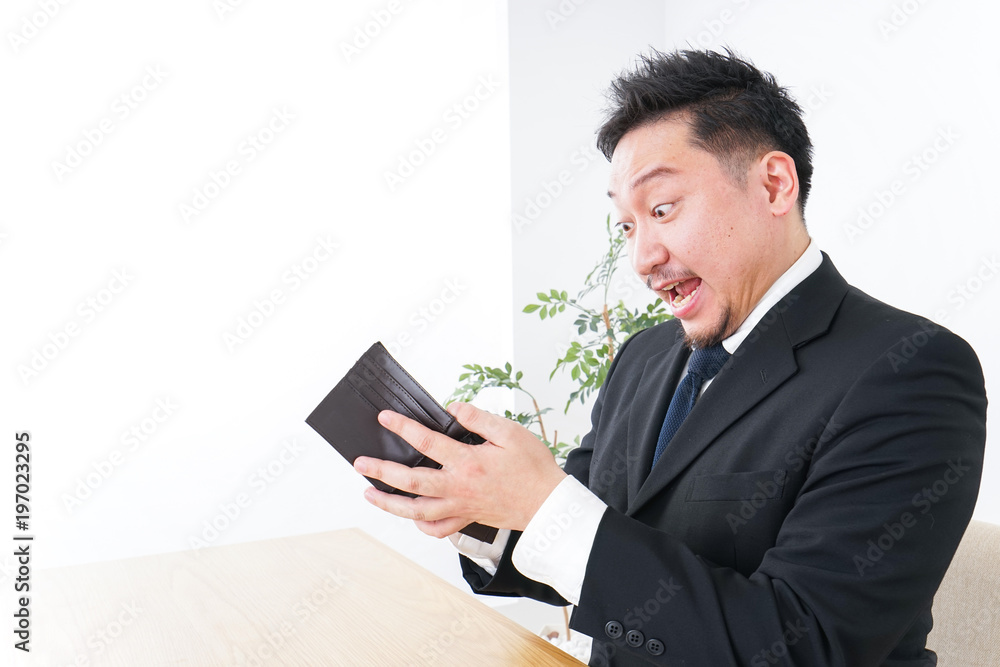 Businessman being suprised at wallet Businessman being suprised at wallet