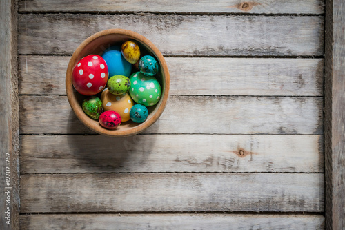 eggs of different colors, polka dot eggs, chicken and quail eggs scattered on Board background