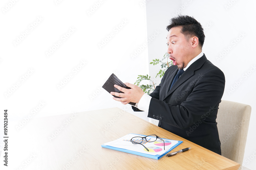 Businessman being suprised at wallet Businessman being suprised at wallet