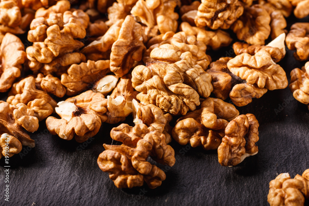 Walnut on a dark rustic wooden background Walnut on a dark rustic wooden background