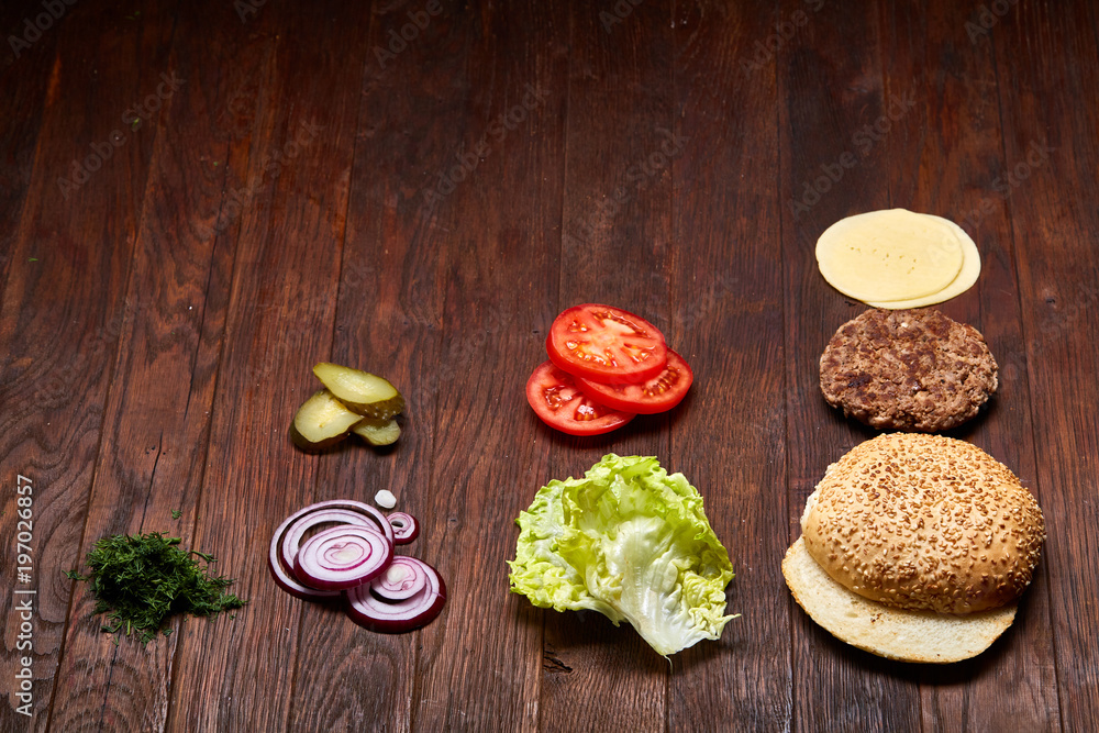 Tasty hamburger ingredients are laid out separately from above, beautifully harmoniously, close-up, top view Tasty hamburger ingredients are laid out separately from above, beautifully harmoniously, close-up, top view