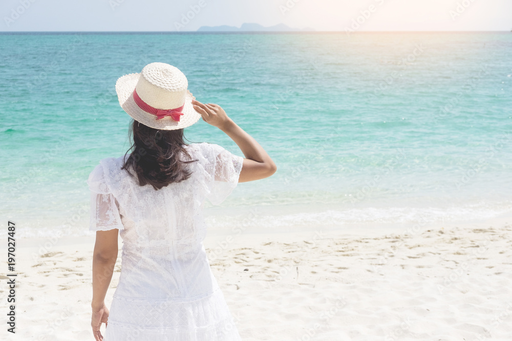 a beautiful carefree Woman relaxing at the beach enjoying her sun dress freedom wear. a beautiful carefree Woman relaxing at the beach enjoying her sun dress freedom wear.