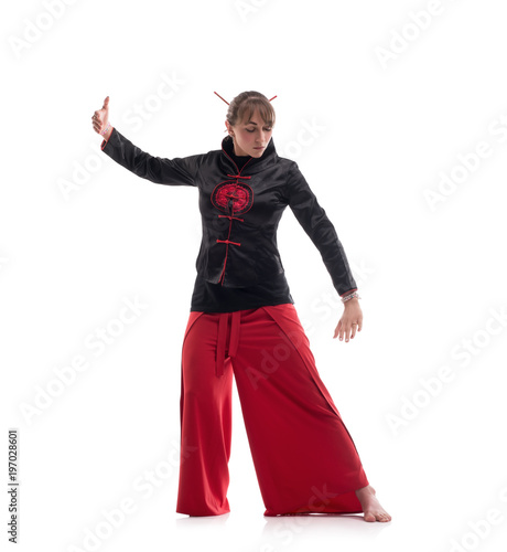 Woman in chinese clothes practicing wushu photo