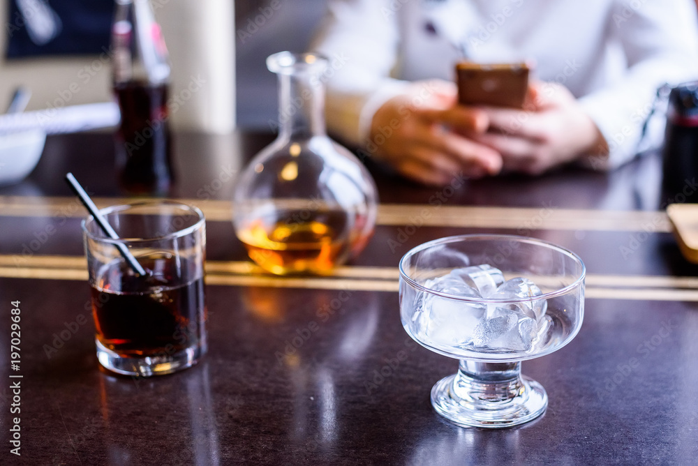 Glass of cola and ice cubes on restaurant table Glass of cola and ice cubes on restaurant table