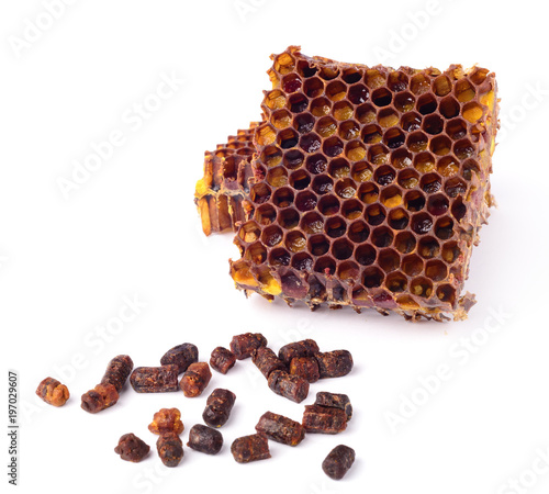 Bee granules and a piece of honey cells are isolated on a white background. Natural remedy for immunity enhancement. Beekeeping products. Apitherapy. photo