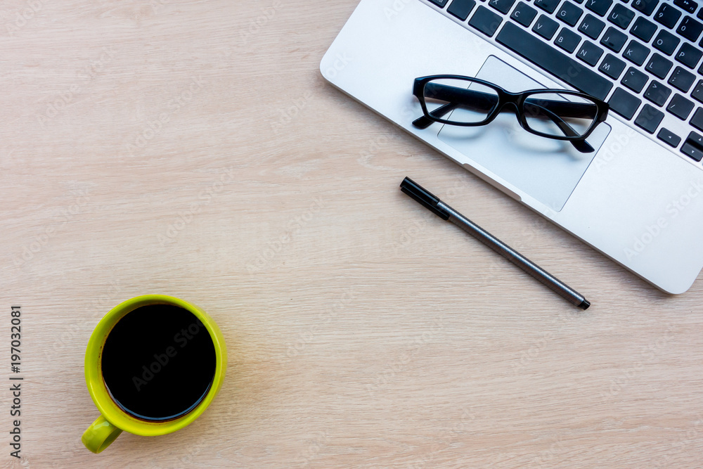 Office desk wood table with notebook and coffee cup, Top view with copy space. Office desk wood table with notebook and coffee cup, Top view with copy space.