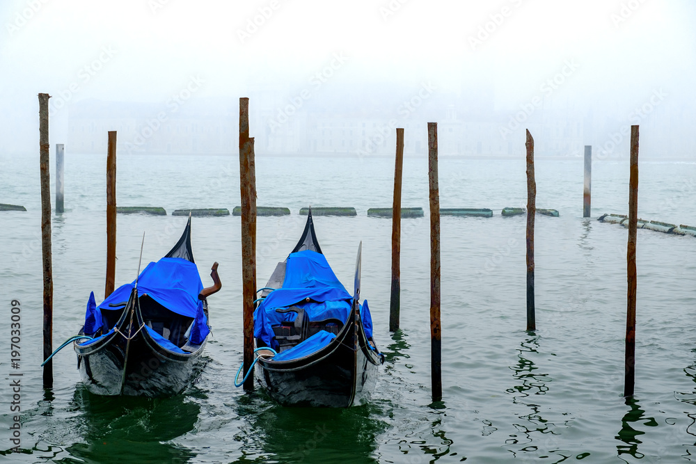 Venice gondolas parked at San Marco square, a foggy morning with gray sky Venice gondolas parked at San Marco square, a foggy morning with gray sky