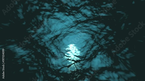 4K Looping animation of water waves from underwater with floating plankton. Light rays shining through. Background. Deep sea dark blue. Motion graphic and animation background.