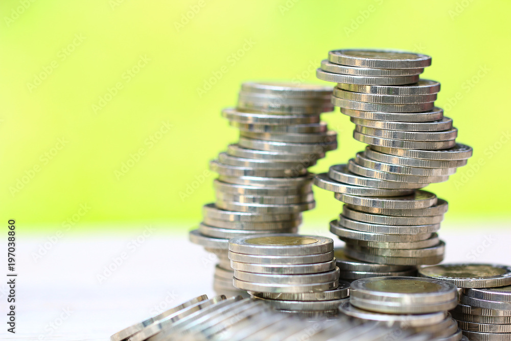 Saving money, Stack of coins money on natural green background Saving money, Stack of coins money on natural green background