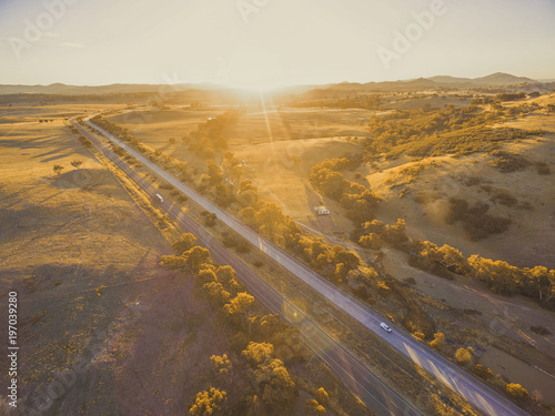 Aerial view of Hume Highway passing through scenic countryside at sunset in Australia photo