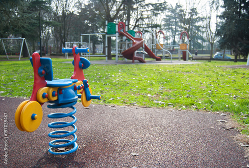 Spring with motorbike for children in a playground - Italy