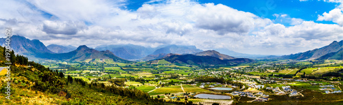 Panorama view of the Franschhoek Valley in the Western Cape of South Africa with its many vineyards in the Cape Winelands, surrounded by the Drakenstein mountain range, as seen from Franschhoek Pass photo