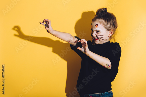 Photography Young child with cat make up streching her hands