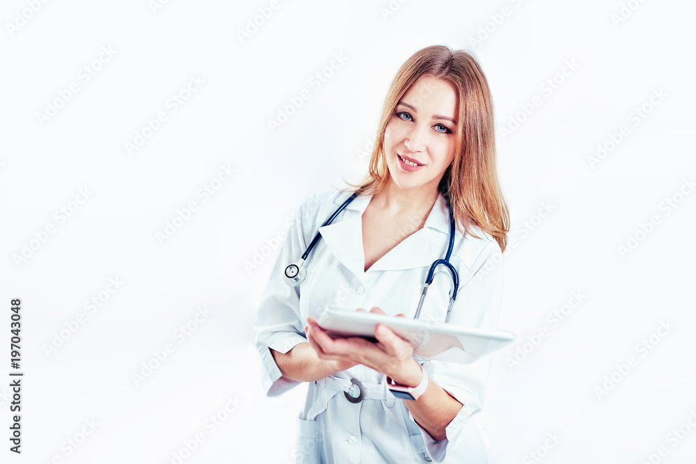 doctor in white medical coat is using a tablet and smiling while standing against window doctor in white medical coat is using a tablet and smiling while standing against window